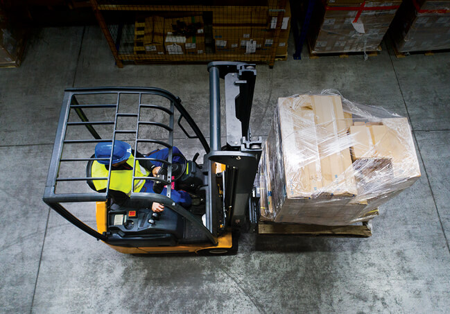 Forklift carrying load indoors